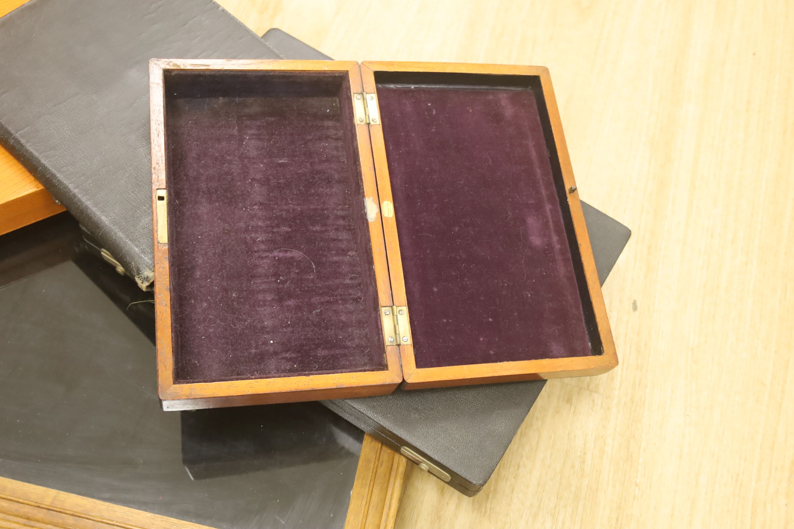 A glass table top cabinet and a collection of pen boxes